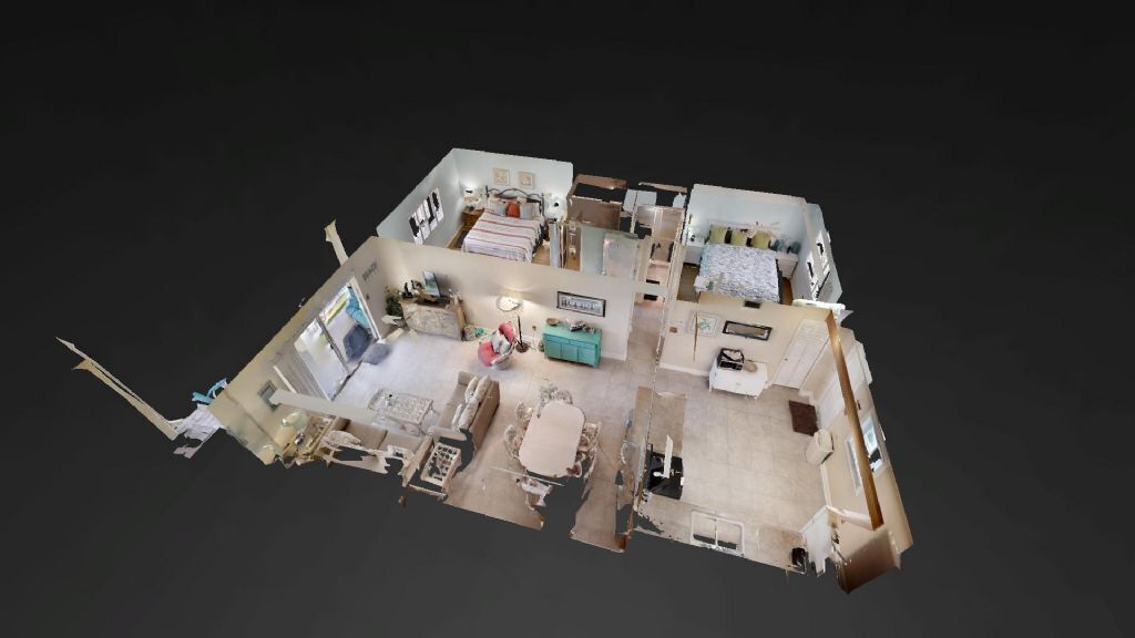 Ein 3D-Modell eines Hotelzimmers mit Bett, Schreibtisch, Stuhl und einer kleinen Küchenzeile.