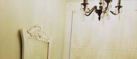 A bathroom with a sink, mirror, and window with blinds.