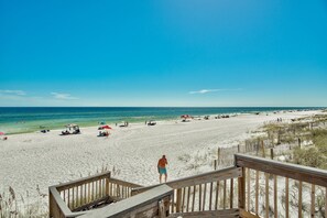 Relax on the expansive beach with access to the calm sea waters.