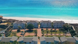 A beachfront hotel with multiple buildings, a central courtyard, and a view of the ocean. - Beautifully Decorated Gulf Front Townhome In Private Gated Community (Santa Rosa Beach)