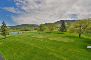 A golf course with well-maintained grass, trees, and a pond. - Private deck, BBQ Grill, view of golf course (Eden)