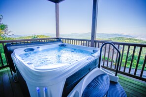 A hot tub on a wooden deck with a view of mountains. - Walk to ski slopes! INCREDIBLE MTN VIEWS,SUNSETS, HOTTUB, FIREPLACE (Sugar Mountain)