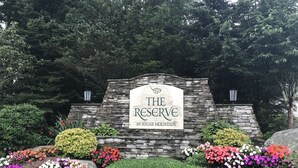 A stone wall with a sign reading "The Reserve at Sugar Mountain". - Walk to ski slopes! INCREDIBLE MTN VIEWS,SUNSETS, HOTTUB, FIREPLACE (Sugar Mountain)