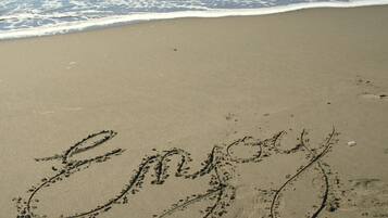 A beach with the word "Enjoy" written in the sand.
