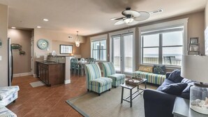 A spacious living area with a kitchen, dining area, and seating with a view.