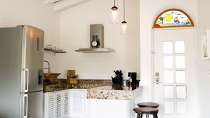 A kitchen with a stainless steel refrigerator, a microwave, a sink, and a countertop with a knife block and a coffee maker. - Marina Golf Condo in the heart of the Marina Vallarta (Marina Vallarta)