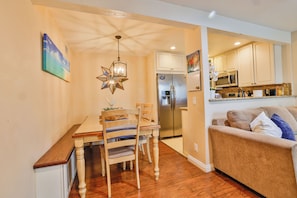 Cozy living space with a dining area, kitchenette, and comfortable sofa.