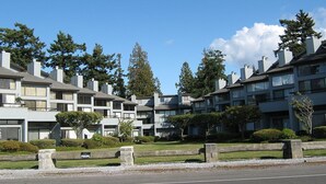 Una hilera de edificios de apartamentos modernos bajo un cielo despejado.