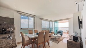 A modern living space with a dining area, kitchen, and a balcony with a view. - Spectacular 2BR with Unbeatable View in Palmetto Beach (Cartagena)