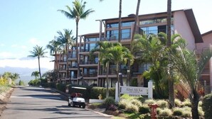 A multi-story hotel with a sign indicating an office on the ground floor. - Rare, Spacious Penthouse, Big Ocean and Mountain Views, Great Location,  AC (Maui)