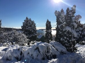 A snowy landscape with trees and a body of water in the background. -  New Well Built Elegant Home on the Water 2 miles to Freeport, 9  to Portland! (South Freeeport)