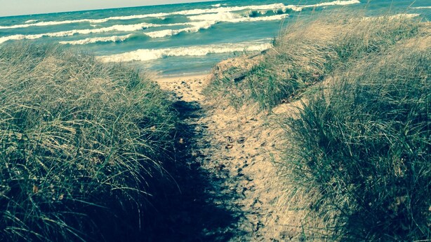 A beach with waves and sand.
