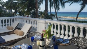 A dining table set with blue and white plates, a vase with flowers, and candles. - "Sought-After" Luxurious 2100 sq ft Oceanfront Private Residence, in a Resort (Montego Bay)