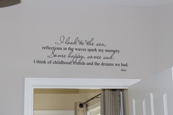 A wall with a quote about memories and childhood friends.