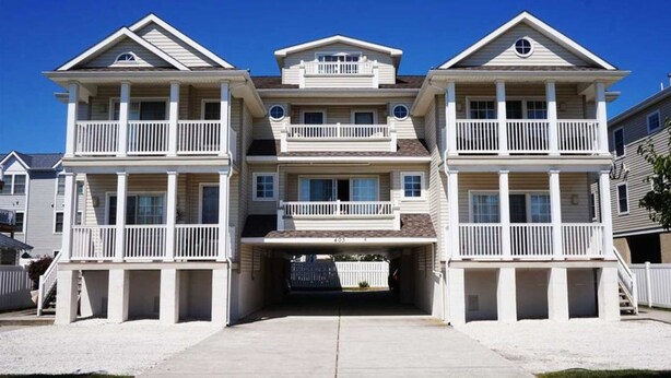 A two-story beachfront house with a covered garage, multiple balconies, and a clear view of the ocean. - Just steps from the Beach and Boardwalk! Perfect vacation getaway! (North Wildwood)