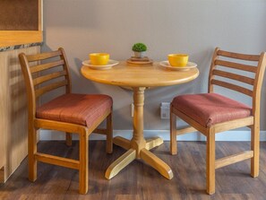 Cozy dining area with a round table and two chairs, perfect for intimate meals.