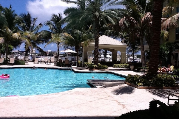 Poolside bliss, hot tub under gazebo, marina beyond pool