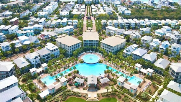 A resort with a central pool, multiple buildings, and a view of the ocean. - Beautiful Home at the Front of Seacrest- 3 Bikes (Panama City Beach)