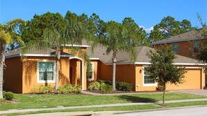 A two-story house with a front yard, a garage, and a small tree. - Ly231617 - Watersong - 6 Bed 4 Baths Villa (Davenport)