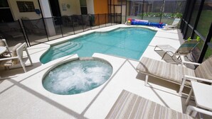 A pool area with a hot tub, lounge chairs, and a view of the outdoors. - Ly231617 - Watersong - 6 Bed 4 Baths Villa (Davenport)