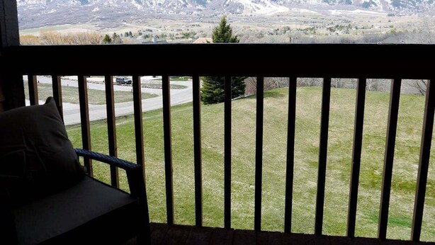 A balcony with a view of snow-capped mountains.