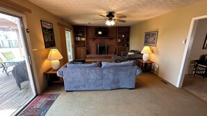 A cozy living room with a fireplace, a sofa, and a television.