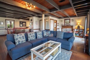 A living room with a sectional sofa, a coffee table, and a fireplace.