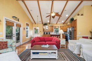 TV, fireplace, DVD player, books - Woodlands Wonder: Cute Oak Island Cottage with Private Pool Welcomes Nightly Res (Oak Island)