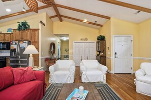 TV, fireplace, DVD player, books - Woodlands Wonder: Cute Oak Island Cottage with Private Pool Welcomes Nightly Res (Oak Island)