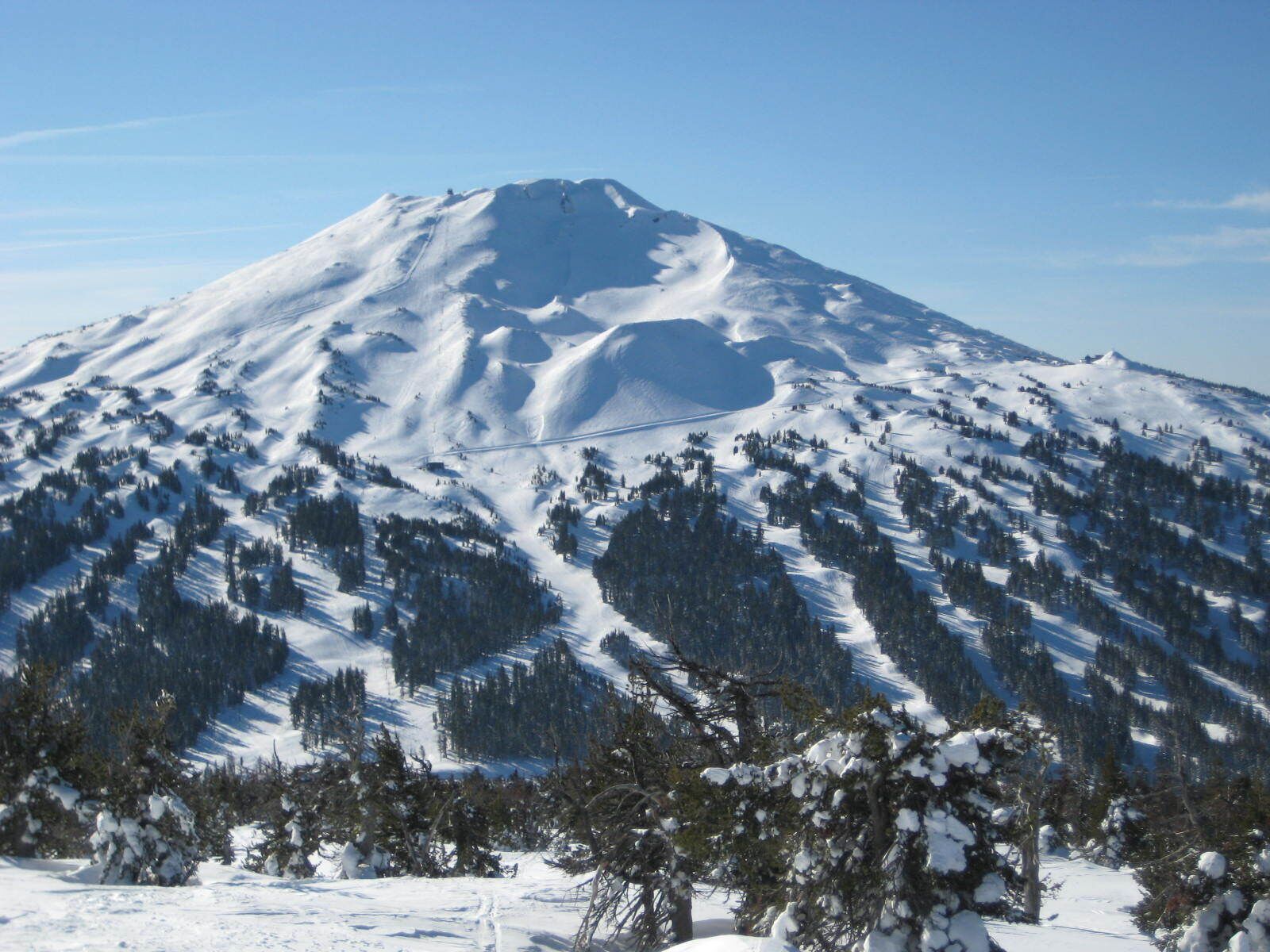 A snow-covered mountain with a clear sky.