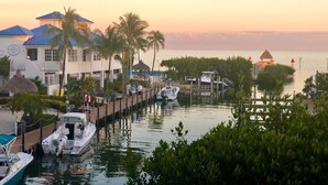 A waterfront property with a dock, boats, and a building with a blue roof. - Ocean Front 2/2 Condo,OCEAN FRONT/MARINA VIEW,Tavernier/Key Largo Fl. Fla.Keys (Tavernier)