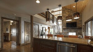 A spacious kitchen with a large island, wooden cabinets, and a built-in dishwasher. - Incredible luxury townhome in downtown Whitefish! 1 block from all downtown shops and restaurants (Whitefish)