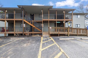 A multi-story building with a covered outdoor area, a staircase, and a parking lot. - Romantic getaway with a view; close to SDC and the Branson Strip (Branson West)