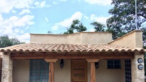 A building with a tiled roof, a wooden door, and stone walls.