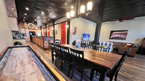A billiards table with chairs and a long table in a restaurant setting. - Historic FireHouse Lodge Very Cool! (COTTER)