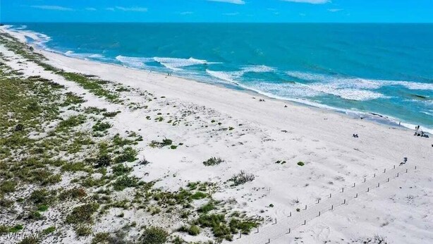 A beach with clear skies and calm waters.