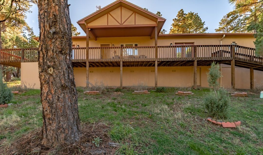 A two-story building with a balcony and a wooden deck.