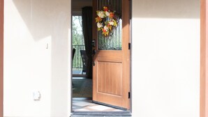 A wooden door with a 'No Smoking' sign, a glass panel, and a floral wreath. -  Country Setting in the Heart of Gold Country - Yet close to it all (Placerville)