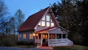 A two-story house with a red roof, a covered porch, and a gravel driveway. - Come and enjoy a beautiful view and relaxing time at Windy Knoll.... (Afton)