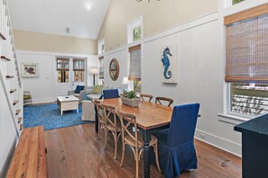 A dining area with a wooden table, chairs, and a blue upholstered chair.