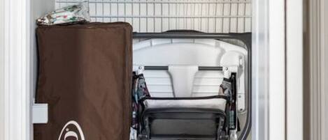 A compact storage unit with a Graco brand mattress protector.