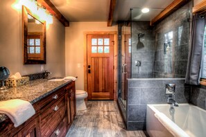 A bathroom with a wooden vanity, a glass-enclosed shower, and a large bathtub. - Rustic Timber | 5-Bedroom Pet Friendly Black Mountain Retreat with Views (Fairview)