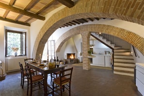 Diningroom/kitchen with fireplace and door to patio and garden