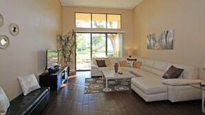 A living room with a sofa, coffee table, and a TV on a stand. - 191LQ PGA WEST LA QUINTA JEWEL ON TPC STADIUM COURSE SPECTACULAR VIEWS (La Quinta)