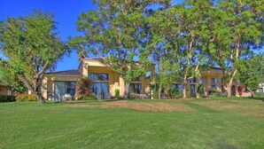 A two-story building with a well-maintained lawn and several trees. - 191LQ PGA WEST LA QUINTA JEWEL ON TPC STADIUM COURSE SPECTACULAR VIEWS (La Quinta)