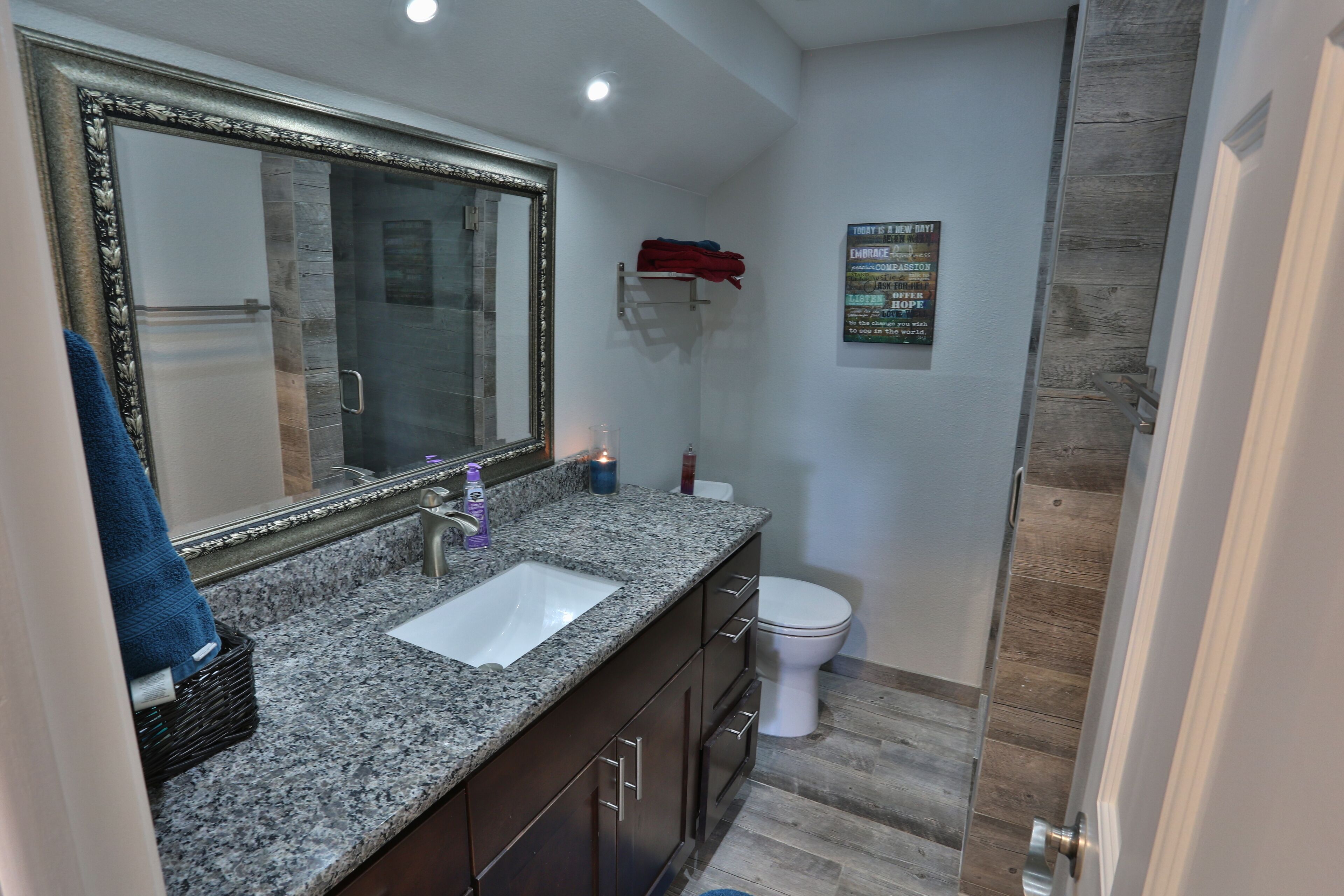 Bathroom with granite counter and shower.  We provide basic toiletries.
