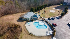 An aerial view of a property with a swimming pool, a covered patio, and a parking area. - Sweet Drake - Unit 2103 - FREE Attraction Ticket with EACH night Stay Including Dollywood (Pigeon Forge)