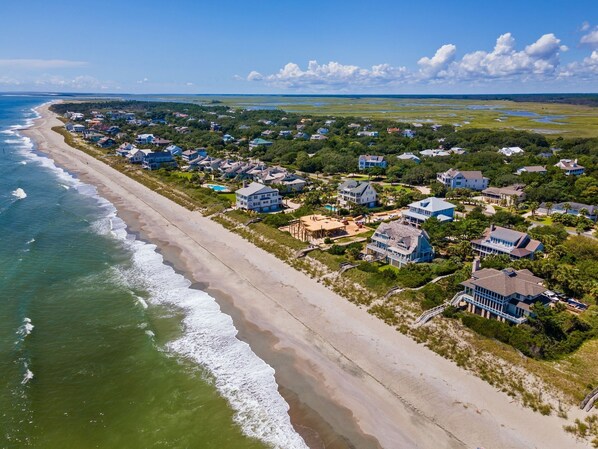 An aerial view of a coastal residential area with houses along the beach and a clear sky. - Relax and Enjoy the Spectacular Views in this Picturesque Home (Georgetown)
