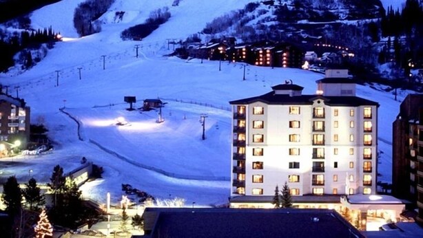 A snow-covered mountain with a ski resort and a multi-story hotel in the foreground. - Sheraton 2BR, 2BA. 100% mountain-front ski in & out.  New Years Week! 1,627 sqft (Steamboat Springs)