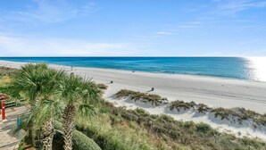 A beach with clear skies, a sandy shore, and some vegetation. - 🌊Beachfront-Balcony-5 Pools-Majestic Beach 1-301🌊 (Panama City Beach)